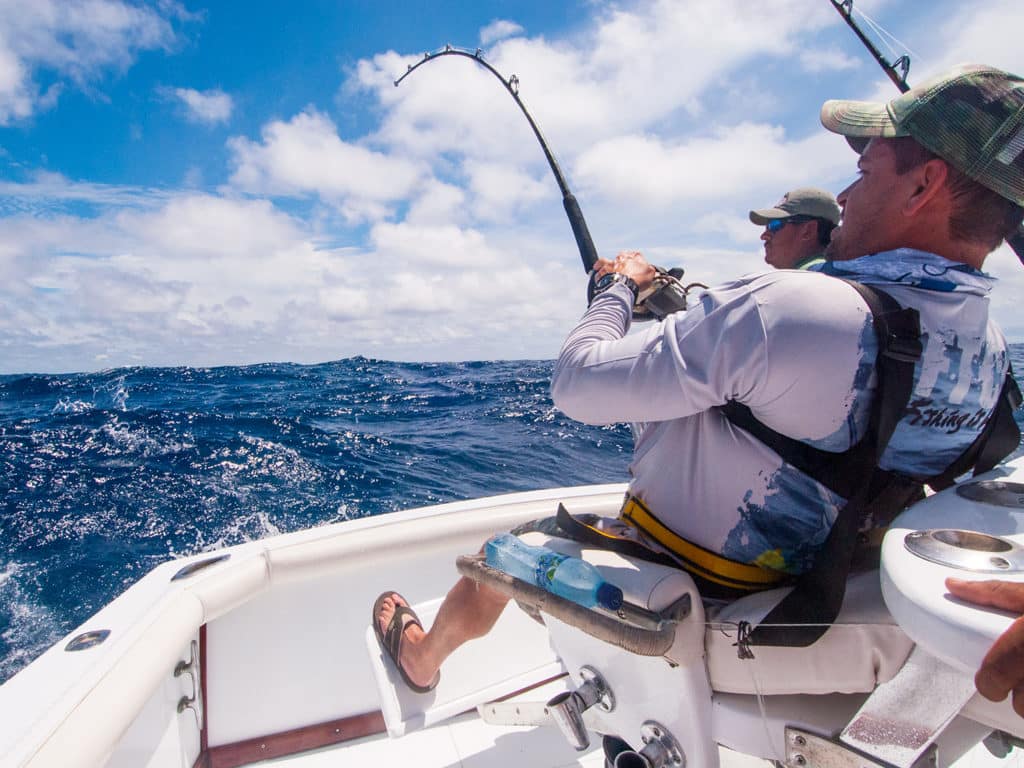 sailfish trolling offshore angler using saltwater fishing reel rod