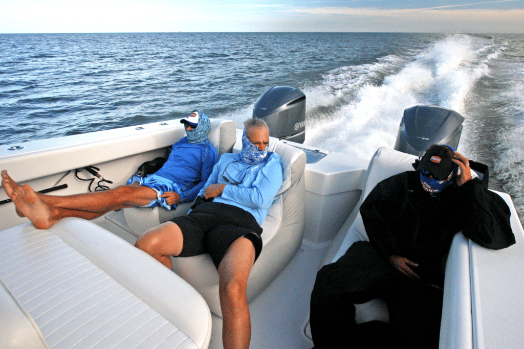 Anglers sitting in bean bag chairs on a center console fishing boat